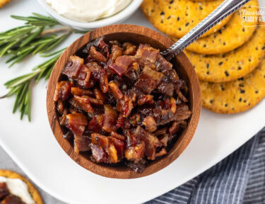 Spoon in a wooden bowl of bacon jam.