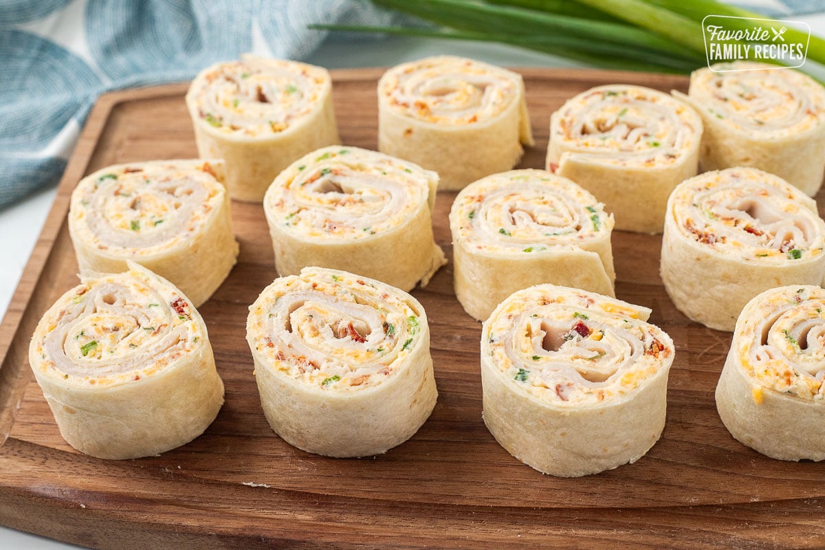 Turkey pinwheels with cream cheese and bacon sliced and arranged on a cutting board