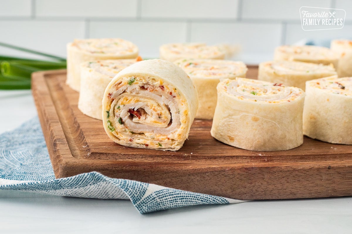 Turkey pinwheels filled with a creamy filling and sliced on a cutting board