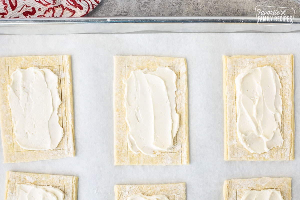 Puff pastry rectangles with cream cheese layer spread in the center.