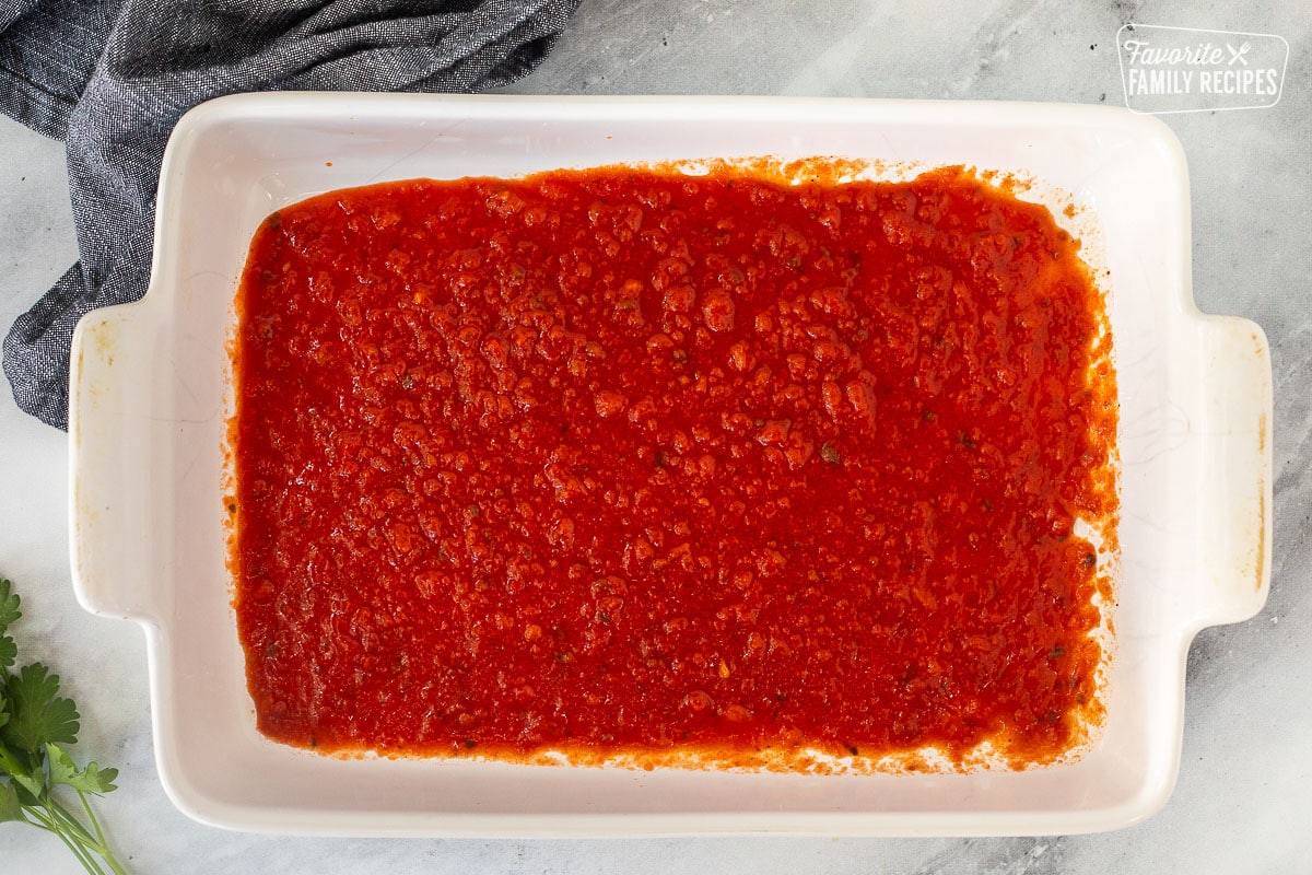 Baking dish with marinara sauce.