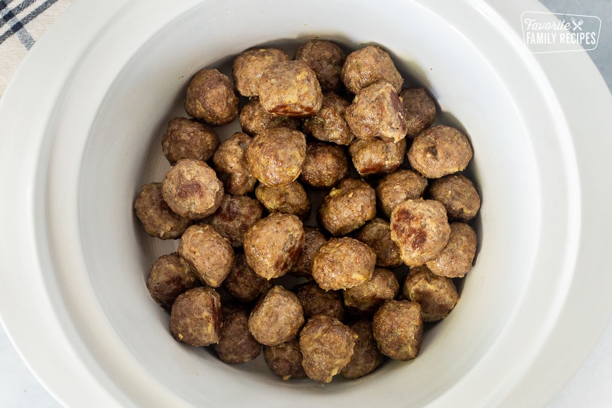 Crock pot with browned meatballs.