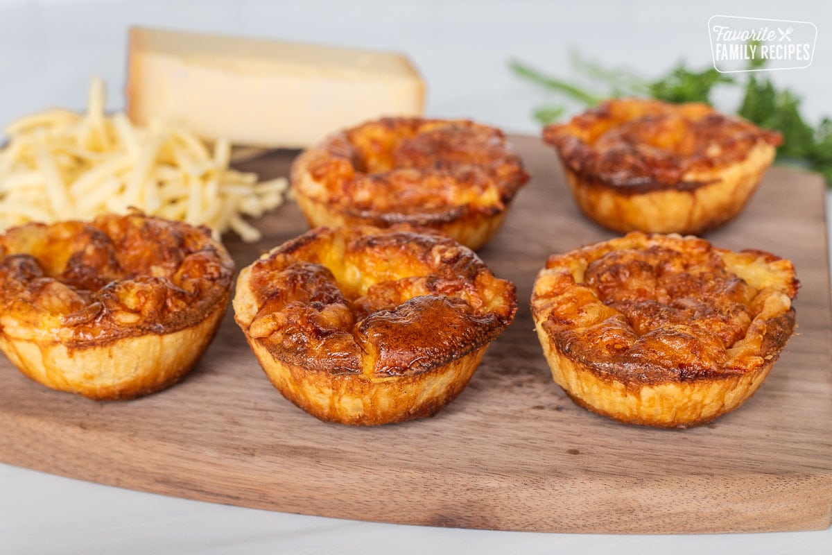 Baked Cheese Pies on a cutting board.