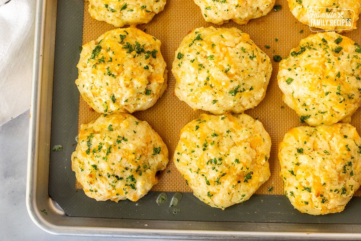 Cheddar Bay Biscuits on a baking sheet lined.