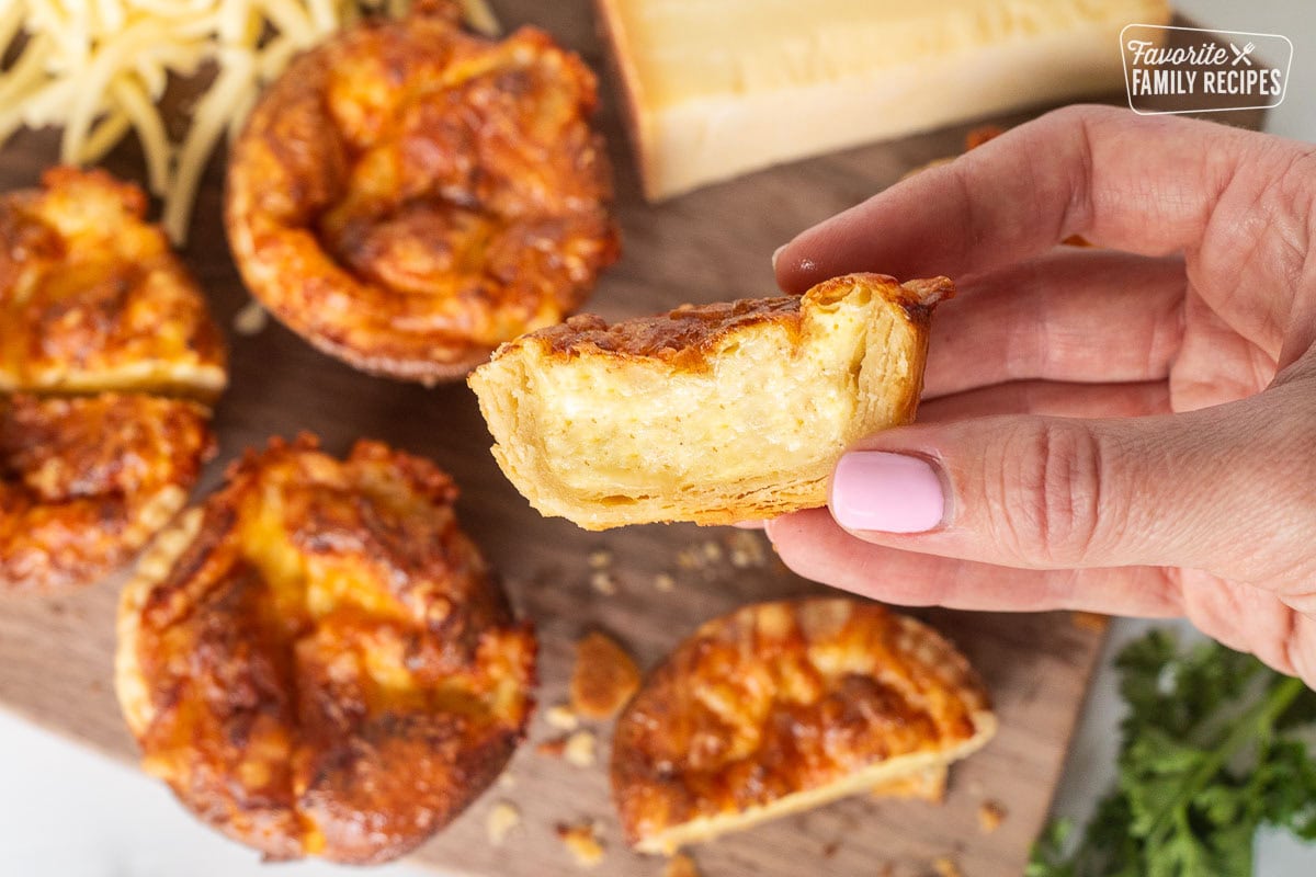 Holding half of a Cheese Pie in hand.