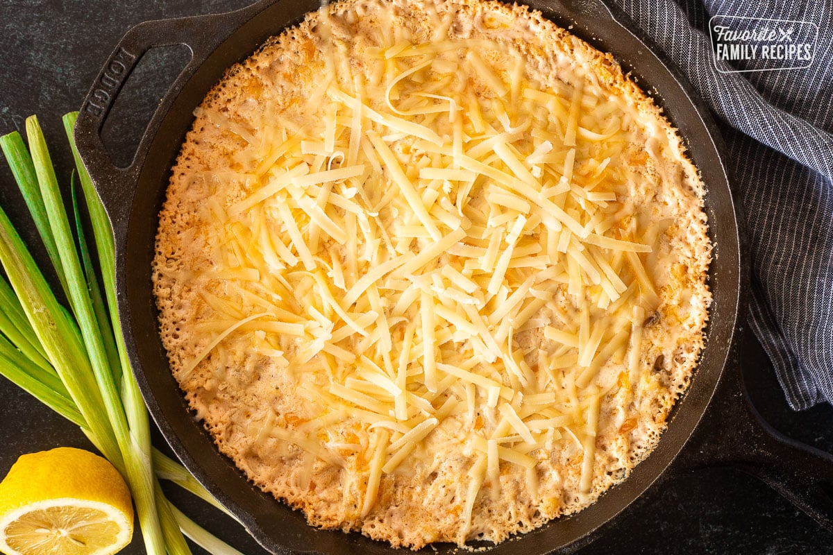 Baked hot crab dip with unmelted parmesan cheese on top.