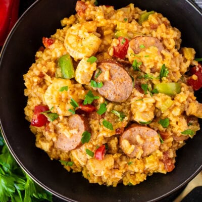 Bowl of jambalaya with sausage, shrimp, chicken and peppers.