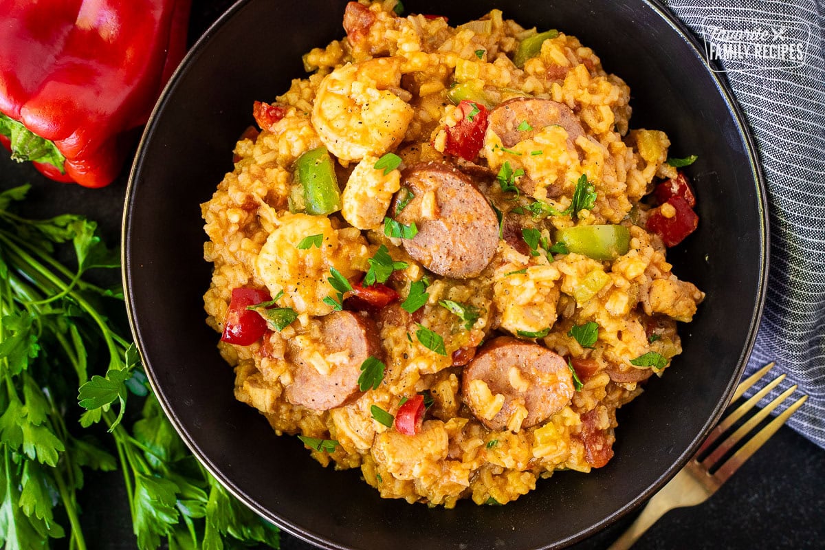 Bowl of jambalaya with sausage, shrimp, chicken and peppers.