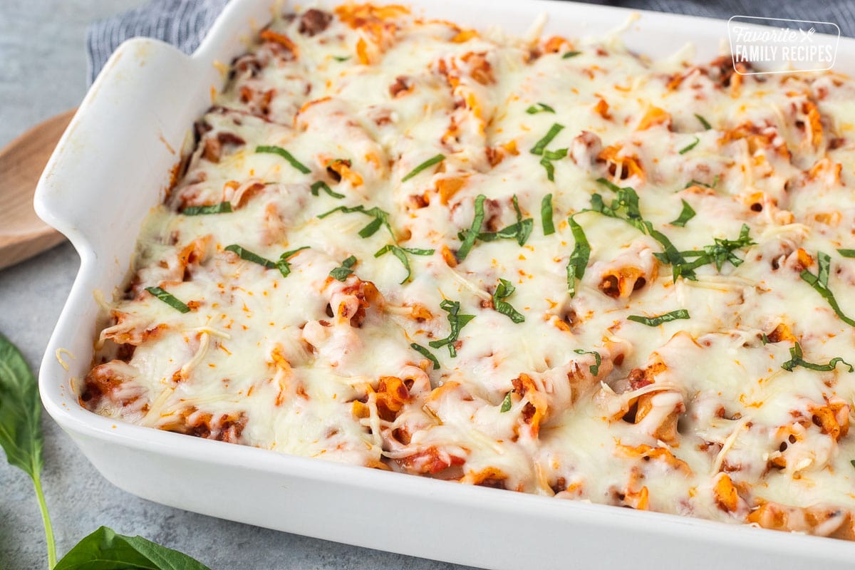 Lasagna casserole and a baking dish with fresh basil on top.