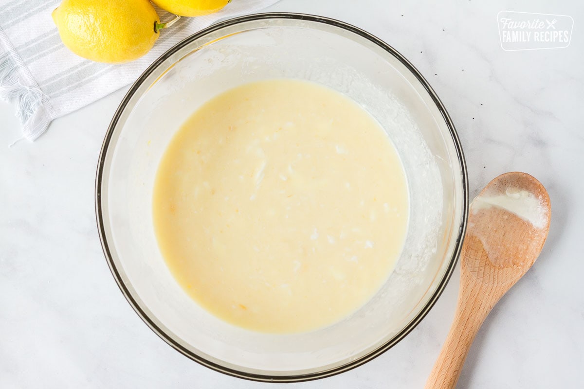 Mixing bowl of wet ingredients to make Lemon Poppy Seed Muffins.