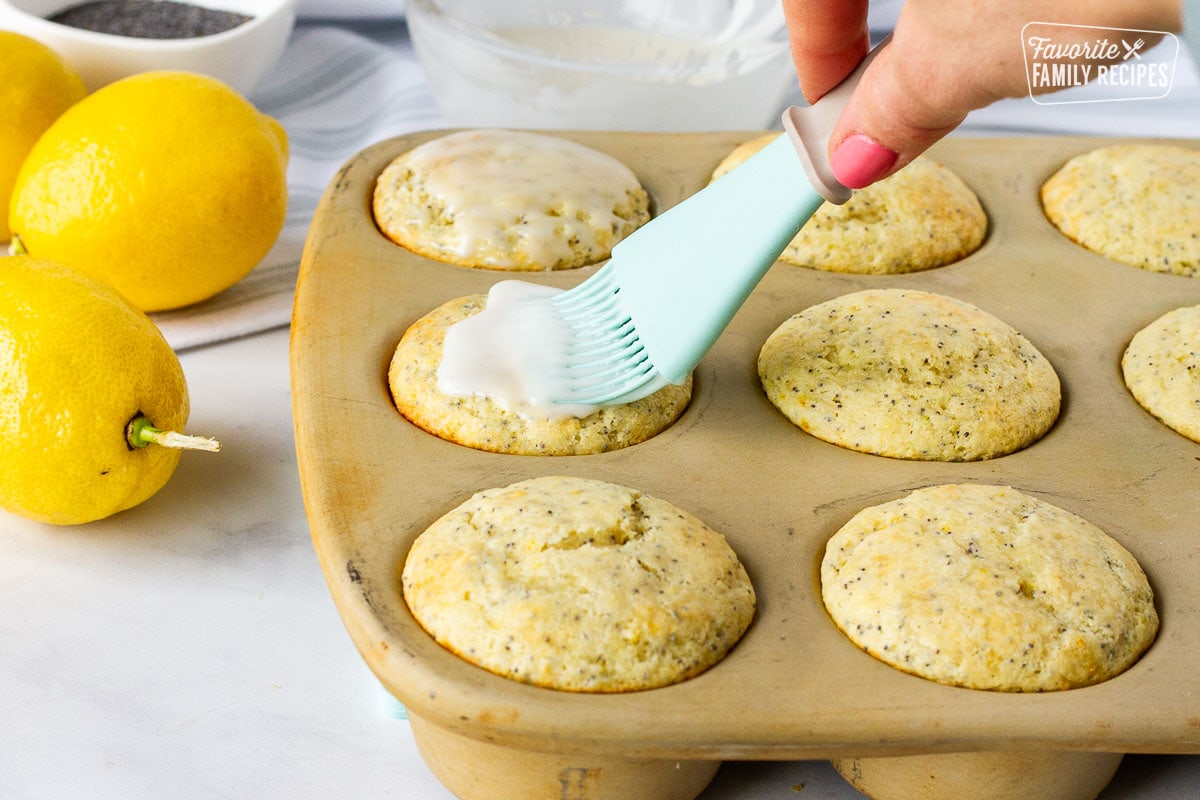 Brushing the glaze on top of the Lemon Poppy Seed Muffins.