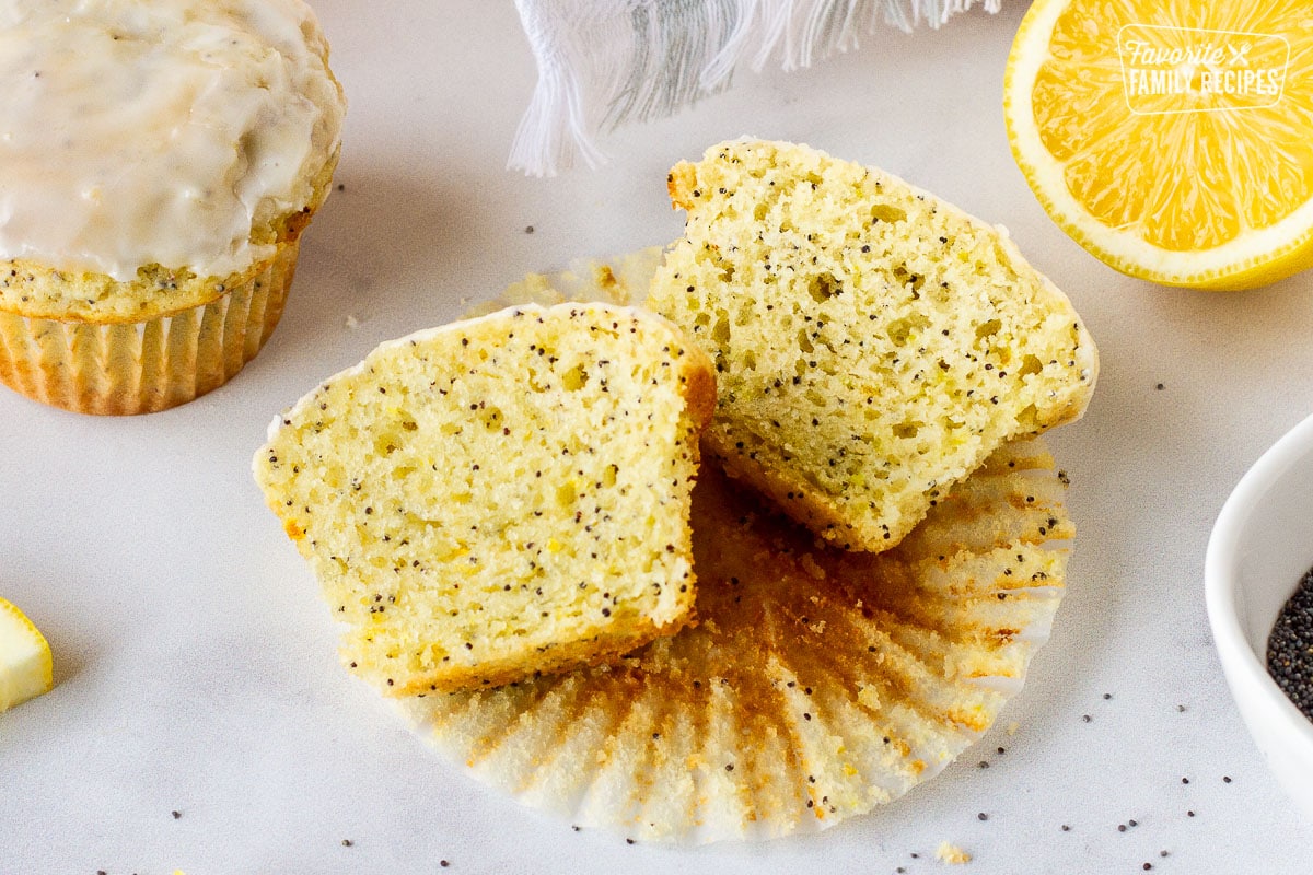 Lemon Poppy Seed Muffin sliced in half on top of a paper liner.