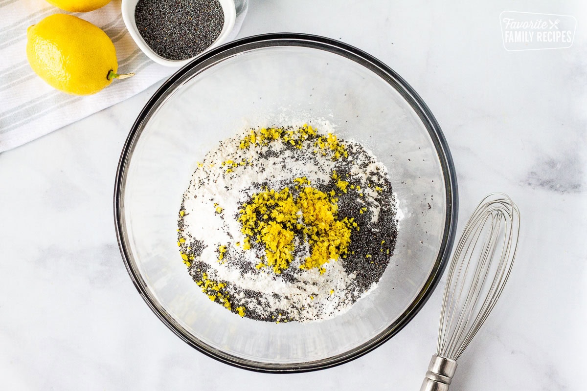 Bowl of flour lemon zest and poppy seeds to make Lemon Poppy Seed Muffins.