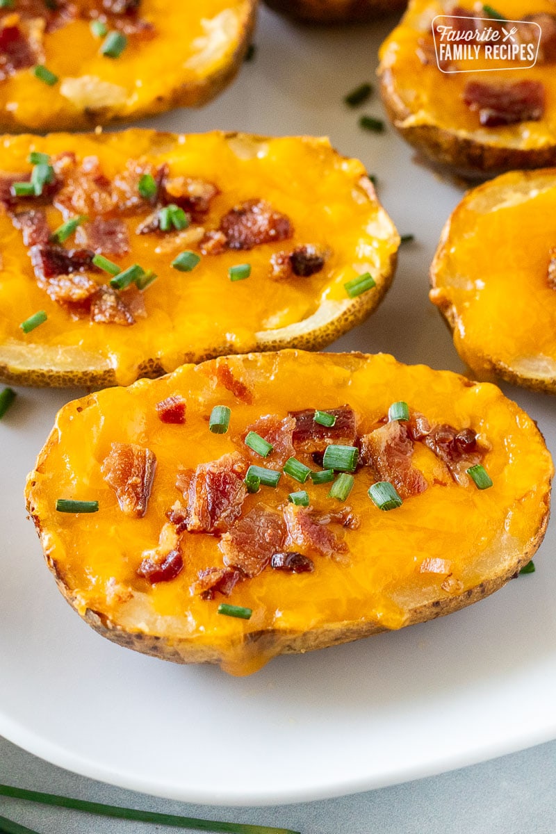 Loaded potato skin with melted cheddar cheese, bacon, and chives.