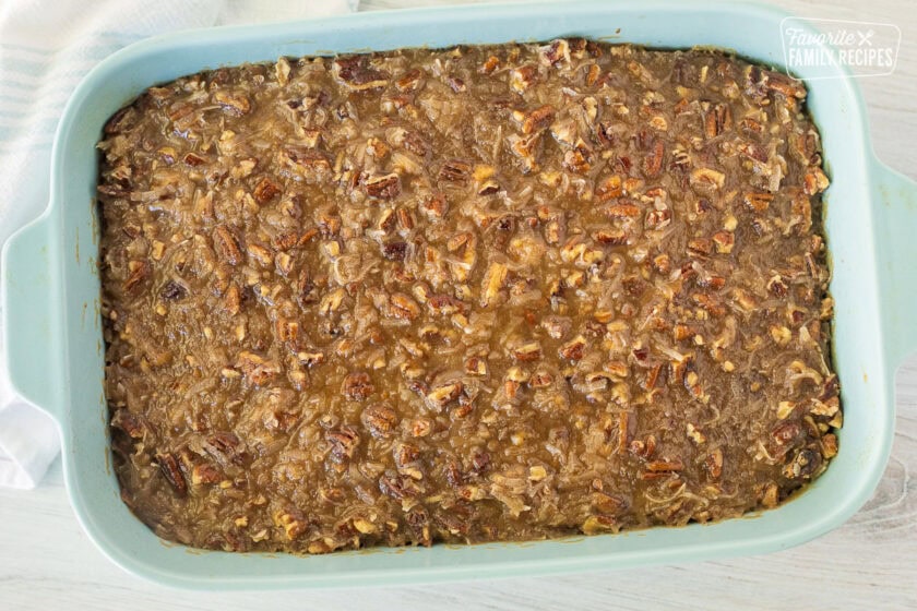 Baked Oatmeal Cake covered with pecan caramel topping in a baking dish.