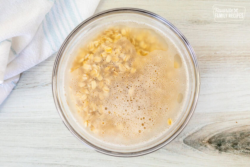 Glass bowl with oatmeal soaking in hot water.