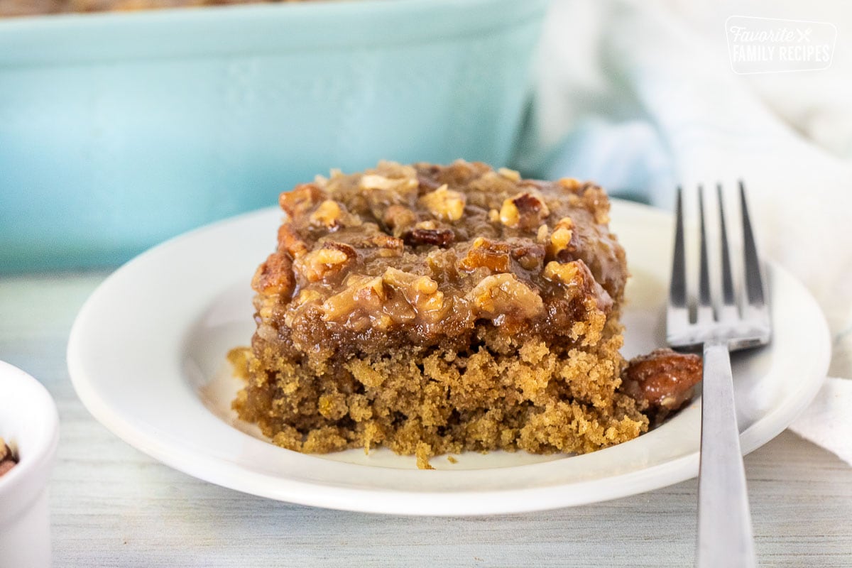 Slice of Oatmeal Cake with a walnut caramel topping on a plate with a fork.