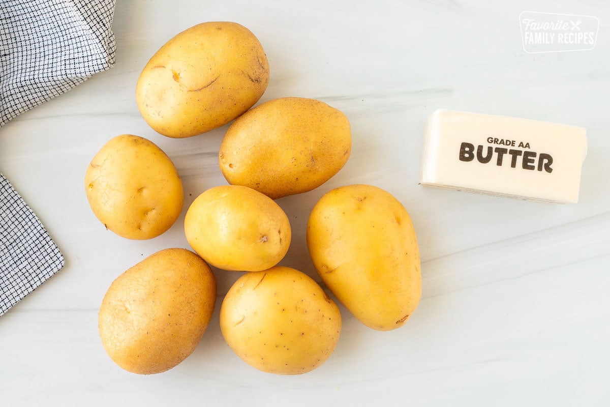 Ingredients to make Rosti including golden potatoes and butter.