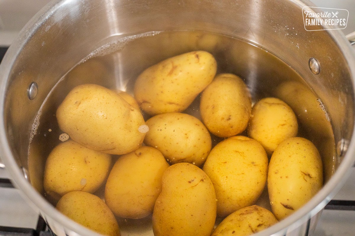 Boiling potatoes in a pot of water.