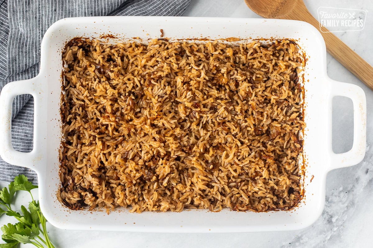 Casserole dish of Stick of Butter Rice. Wooden spoon on the side.