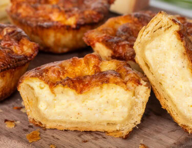 Cheese pie cut in two stacked on each other.