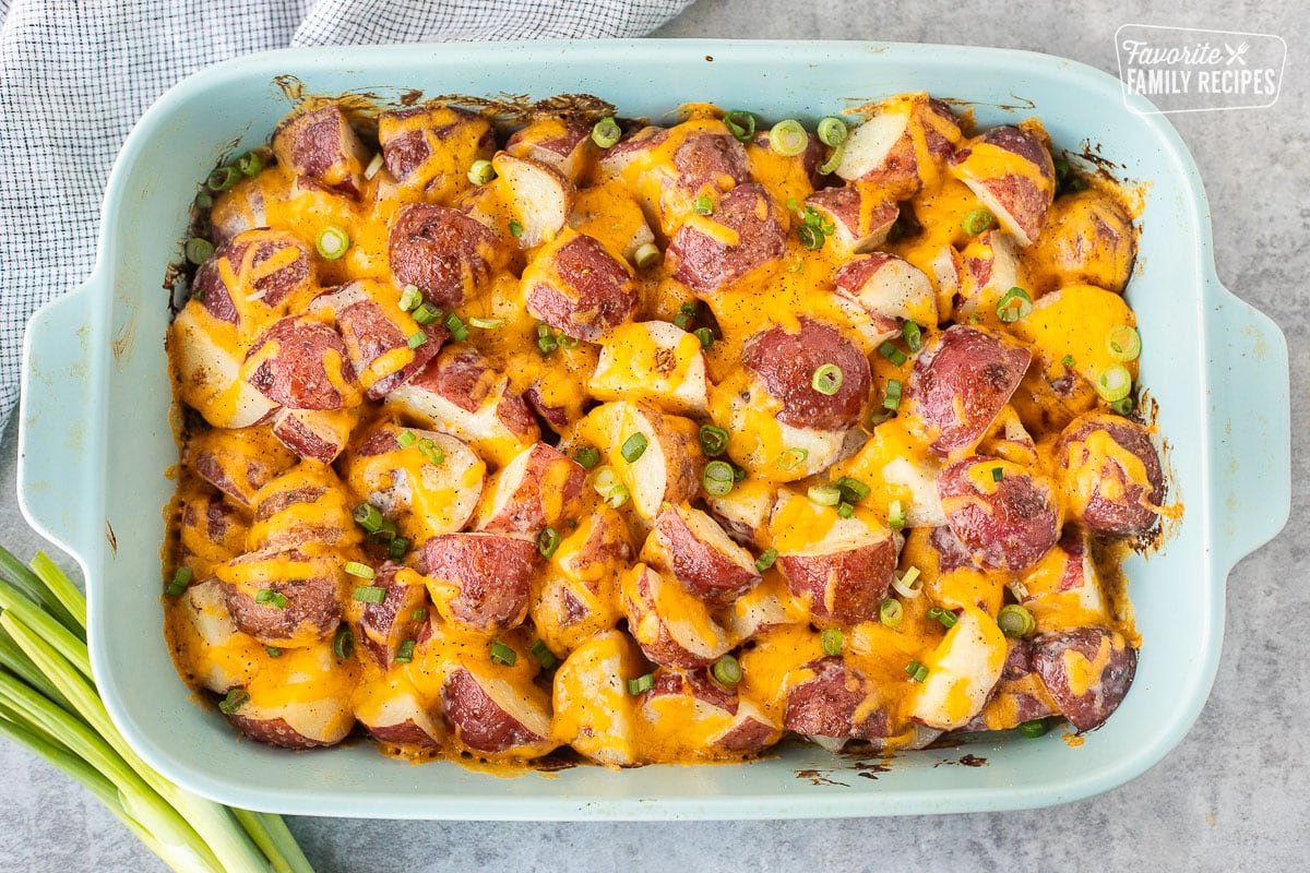 Cheesy Ranch Potatoes in a baking dish topped with green onions.