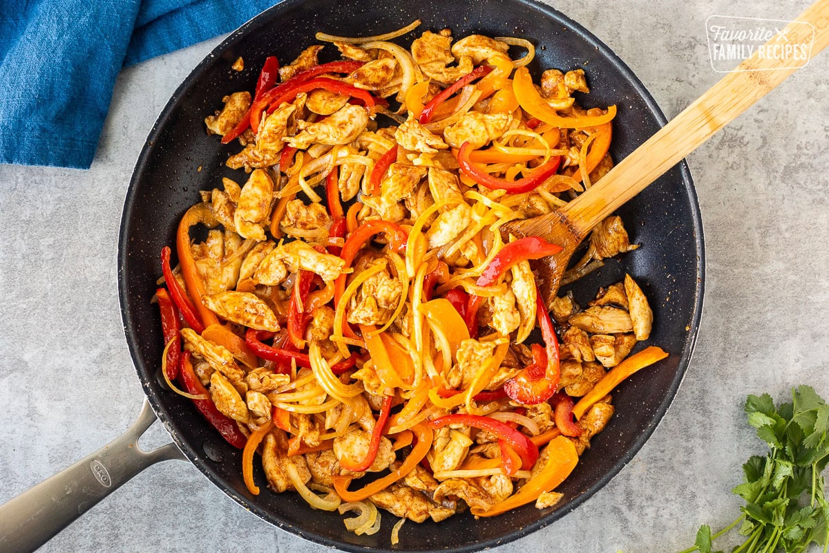 Skillet with chicken, peppers and onions.