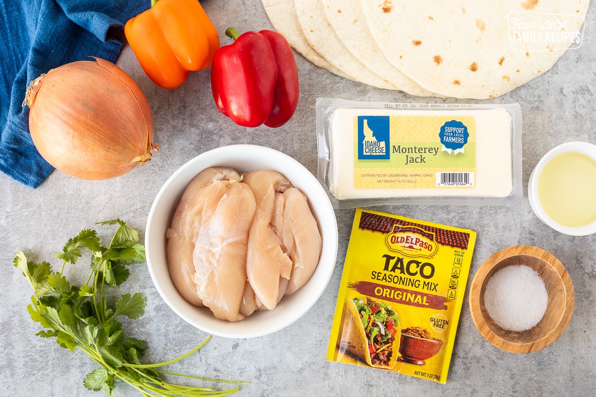 Ingredients to make Chicken Quesadillas including tortillas, chicken, Monterey Jack cheese, oil, taco seasoning, salt, red bell pepper, orange bell pepper, onion and cilantro.