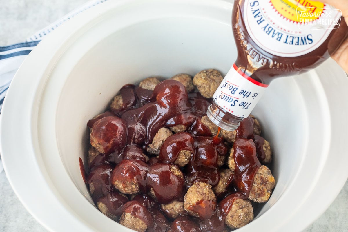 Frozen meatballs in a crockpot topped with Sweet Baby Ray's barbecue sauce.