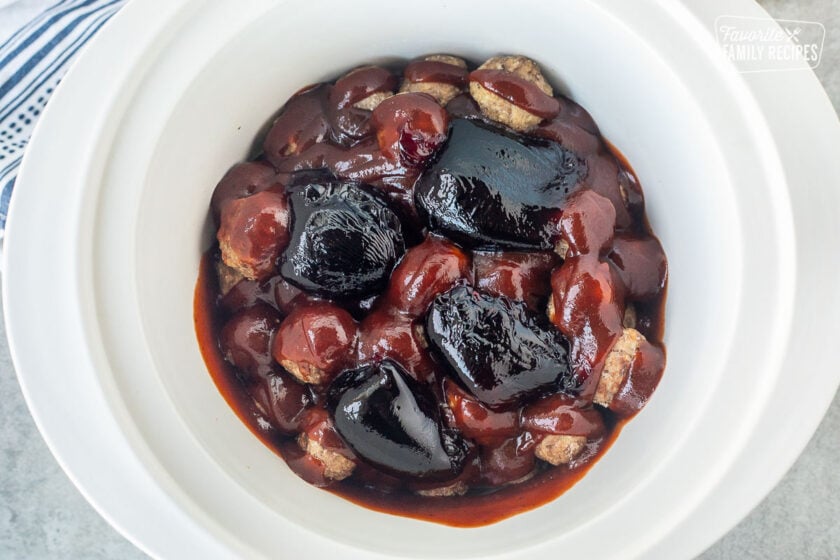 Crockpot with frozen meatballs, barbecue sauce and grape jelly.