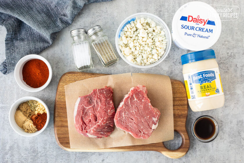 Ingredients to make Grilled Filet Mignon with Blue Cheese sauce including blue cheese, sour cream, mayonnaise, Worchestire sauce, salt, pepper, paprika, spices and filet mignon steaks.