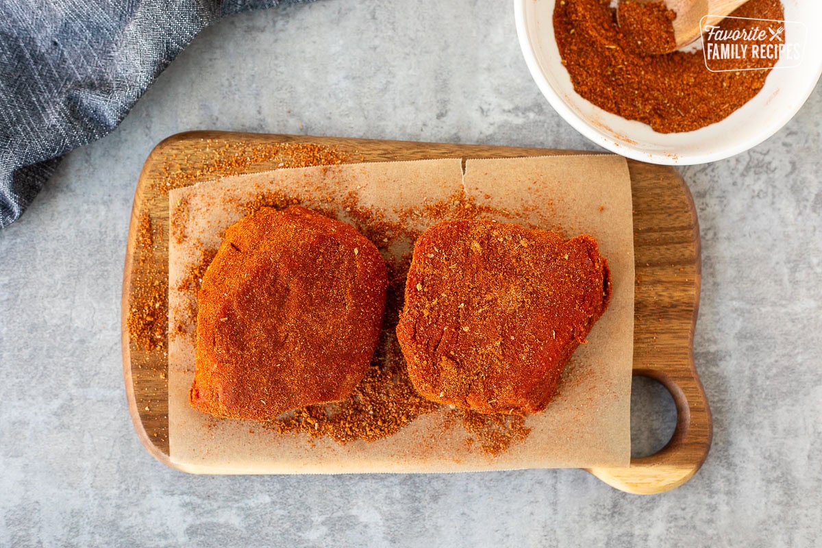 Filet Mignon with dry rub on a board.