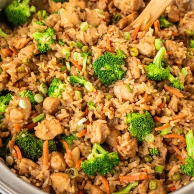 Skillet with One Pot Teriyaki Chicken Bowls and wooden spoon.