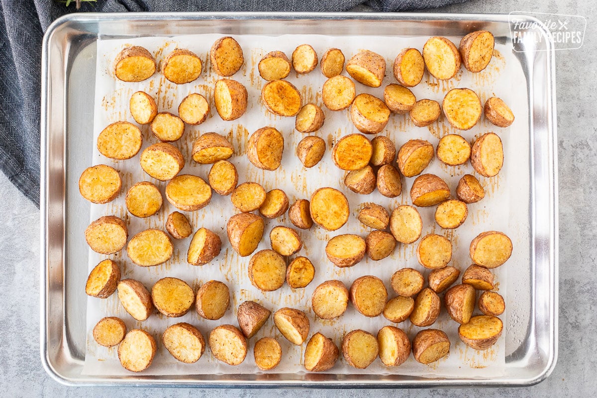 Flipped roasted red potatoes on a baking sheet.