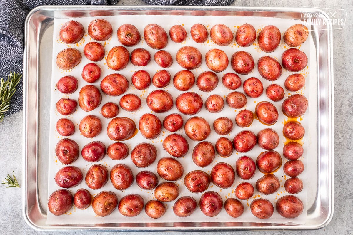 Baking dish with cut red potatoes face side down.