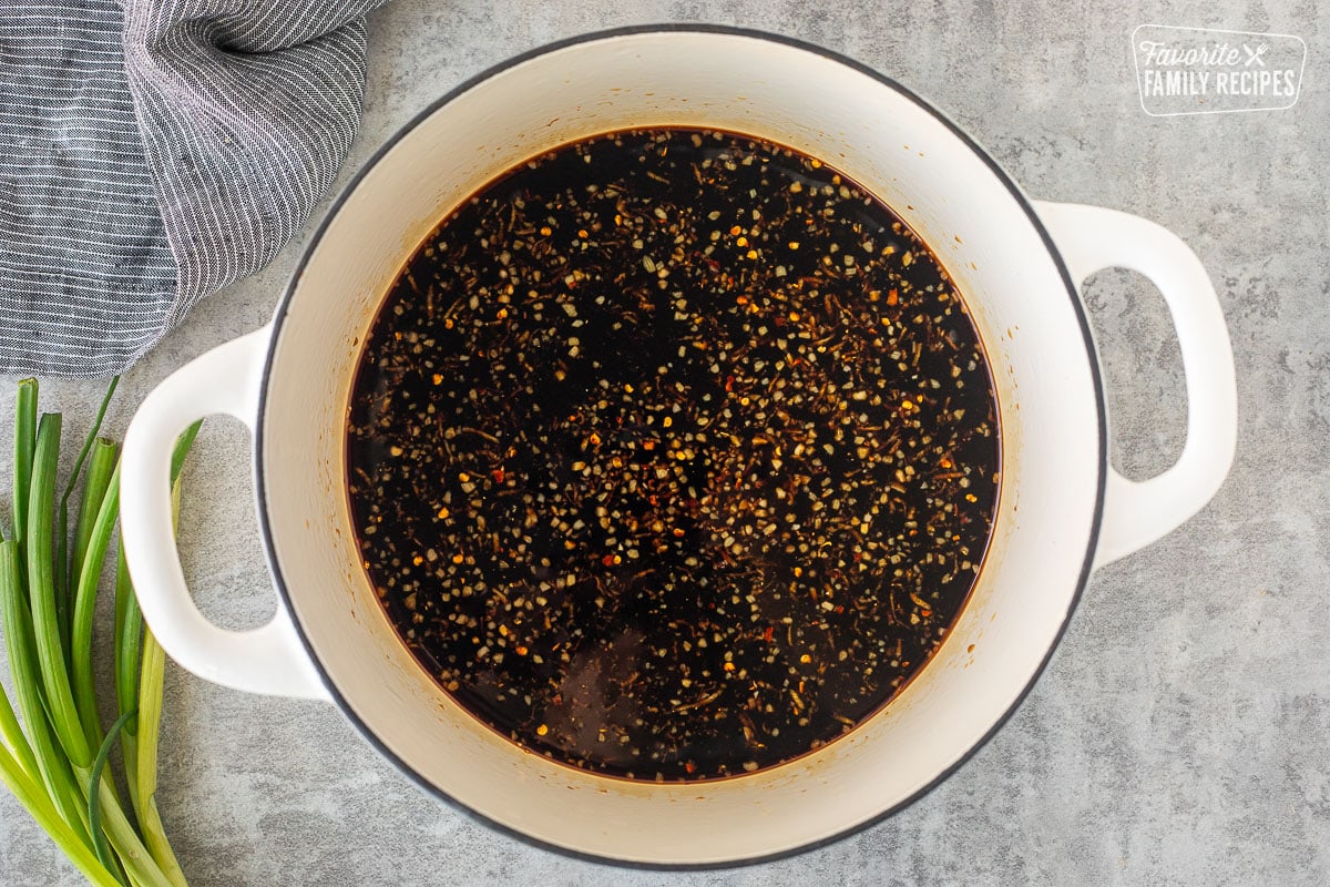 Dutch oven with soy sauce, grated ginger, garlic, water, sugar and crushed red pepper flakes.