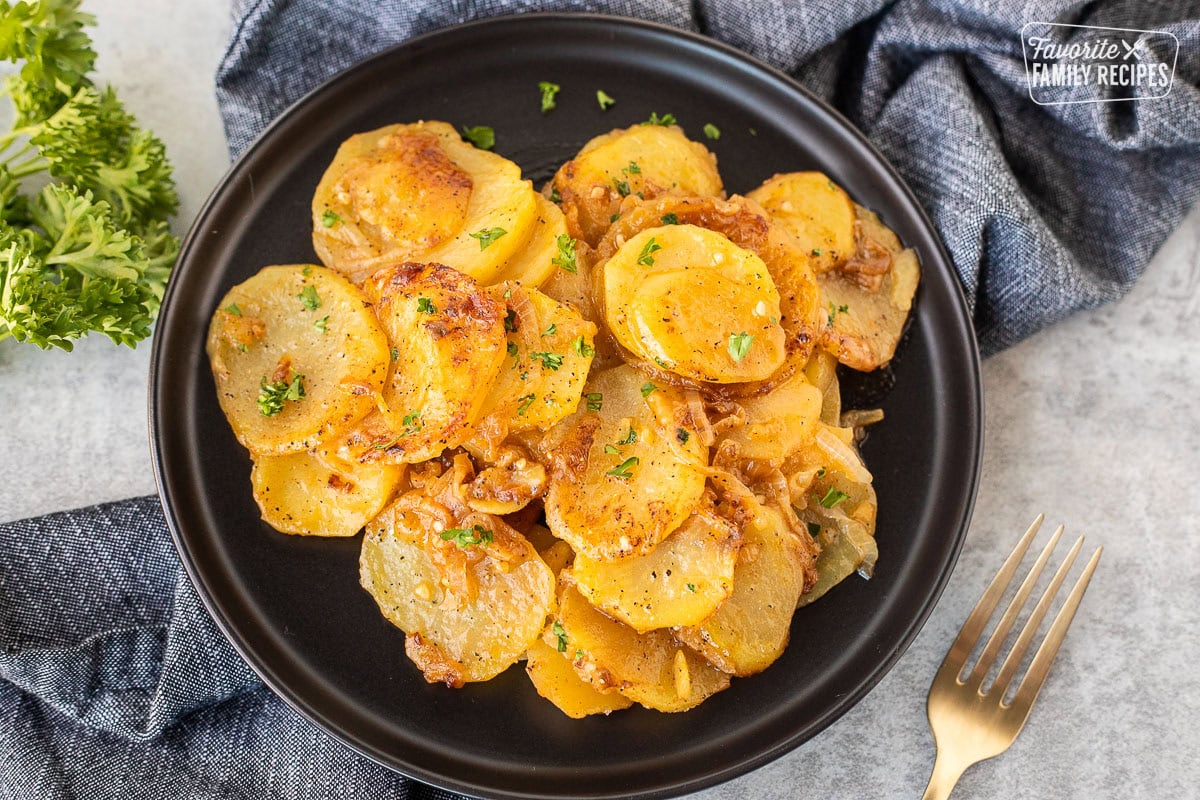 Plate with Smothered Potatoes garnished with fresh parsley.