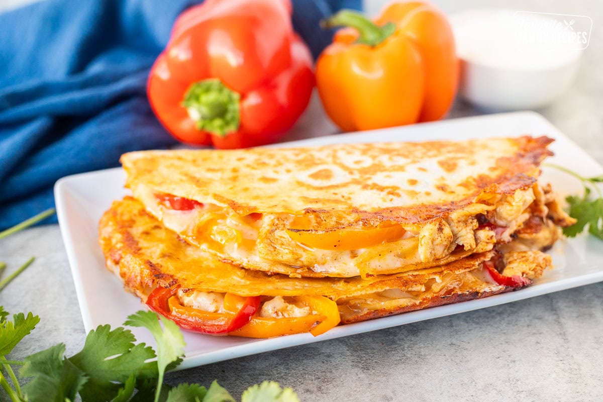 Two chicken quesadillas stacked on a plate.