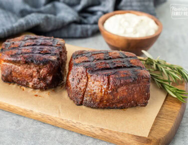 Two Grilled Filet Mignon with Blue Cheese sauce in a bowl.