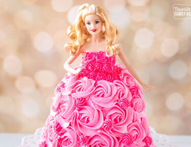 Barbie cake decorated with a pink frosting dress.