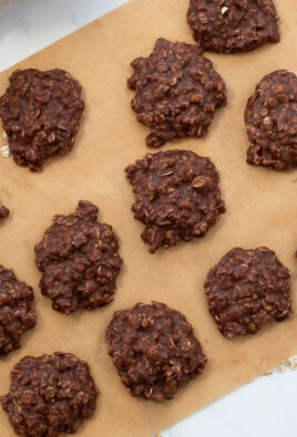 Chocolate no bake cookies cooling on a sheet of brown parchment paper