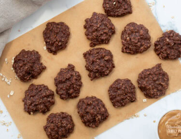 Chocolate no bake cookies cooling on a sheet of brown parchment paper