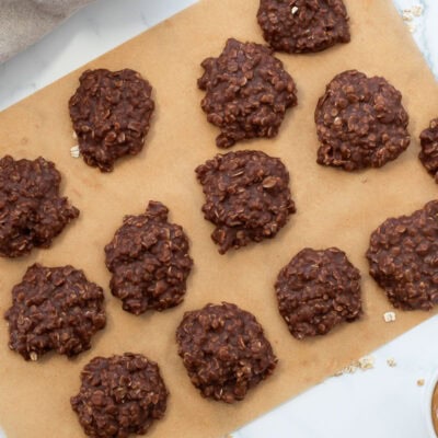 Chocolate no bake cookies cooling on a sheet of brown parchment paper