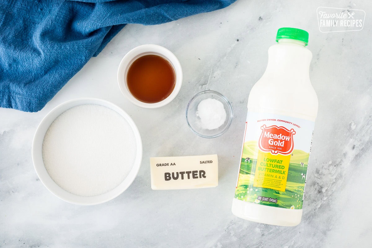 Ingredients to make a buttermilk syrup recipe: buttermilk, butter, vanilla, baking soda, and sugar.