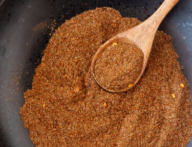 Carne Asada Seasoning mixed with a wooden spoon.