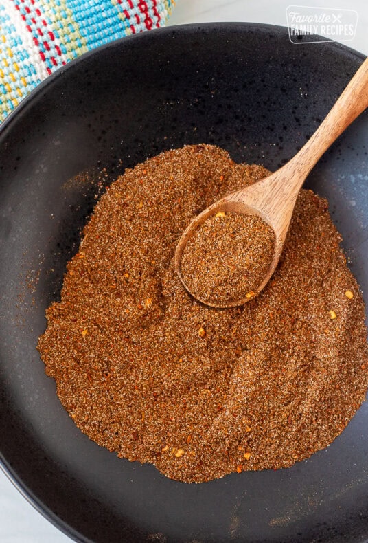 Carne Asada Seasoning mixed with a wooden spoon.