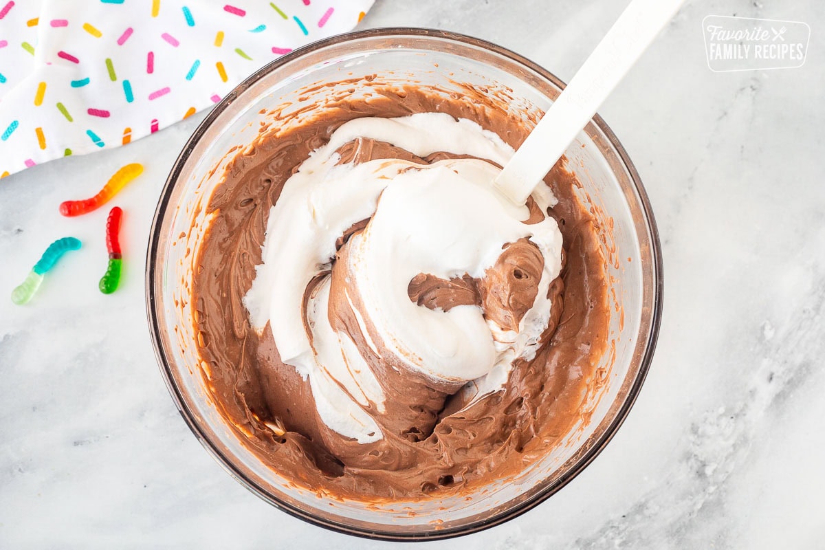 Glass mixing bowl with chocolate pudding and cool whip.