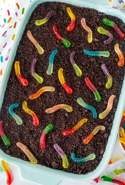 Baking dish of chocolate dirt cake with gummy worms.