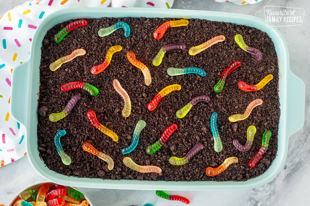 Mini gummy worms on top of Dirt Cake in a casserole dish.