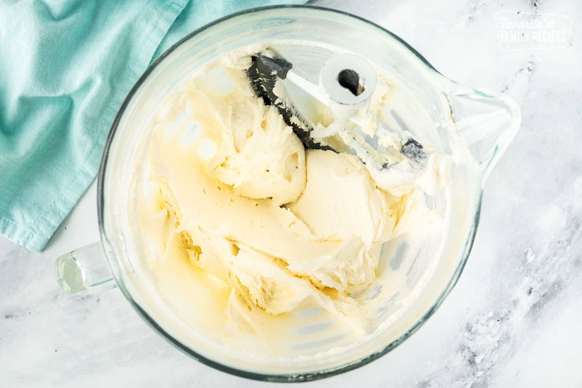 Creamed butter and sugar for Easter cupcakes in a glass mixing bowl.